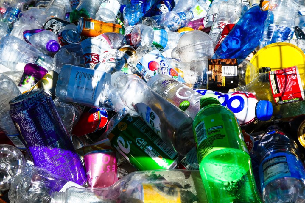 Pile of discarded plastic bottles and aluminum cans